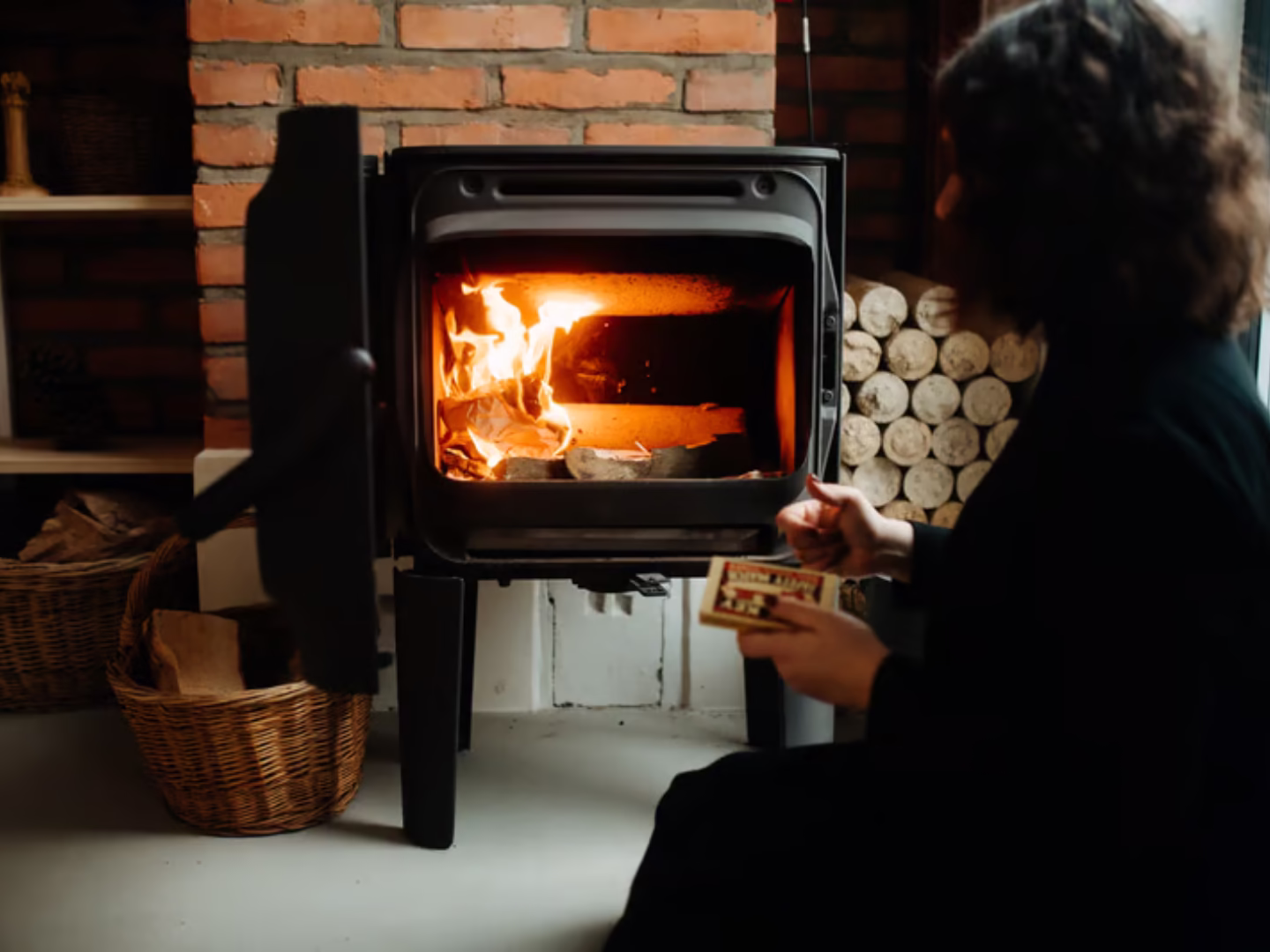 wood burning fireplace with girl