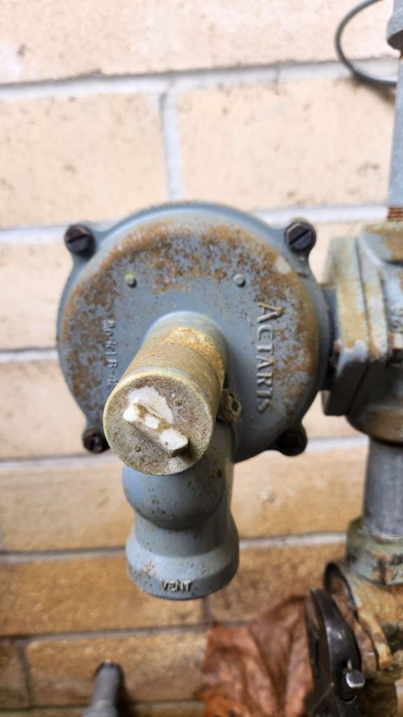 technician performing lp gas lines inspection on propane piping outside central Florida home
