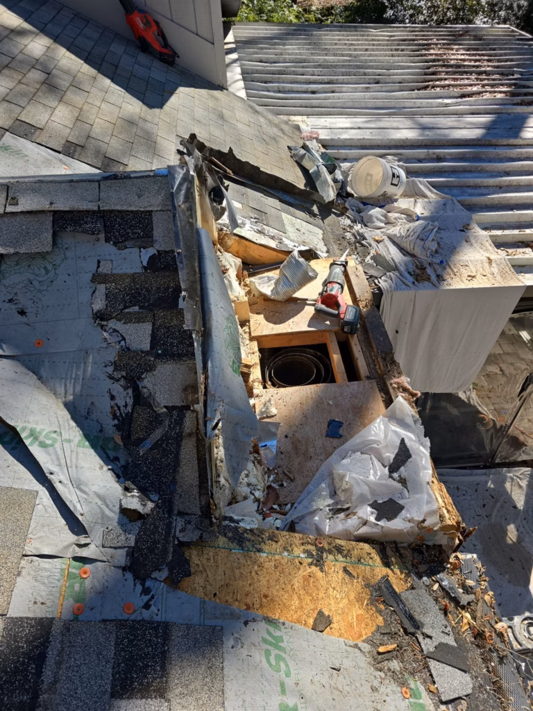 Roof decking and chimney chase reconstruction revealing severe water damage during a leak repair in Gainesville, FL.