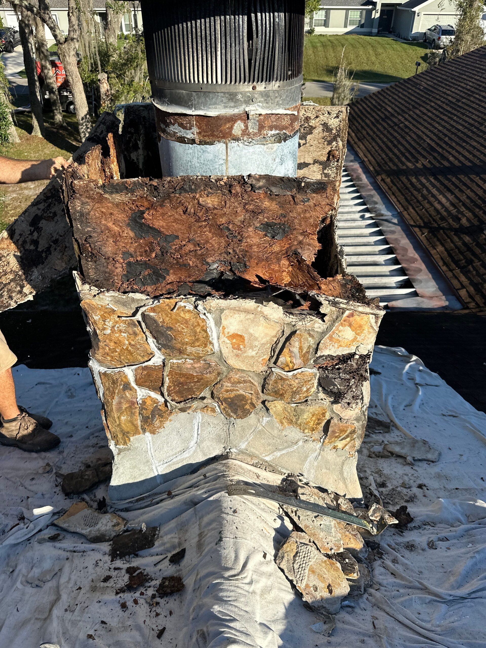 cutaway diagram showing wood chimney framing details around a metal flue with proper air gap
