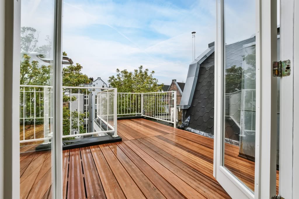 Wood plank deck with white railings built by Always Home Repair