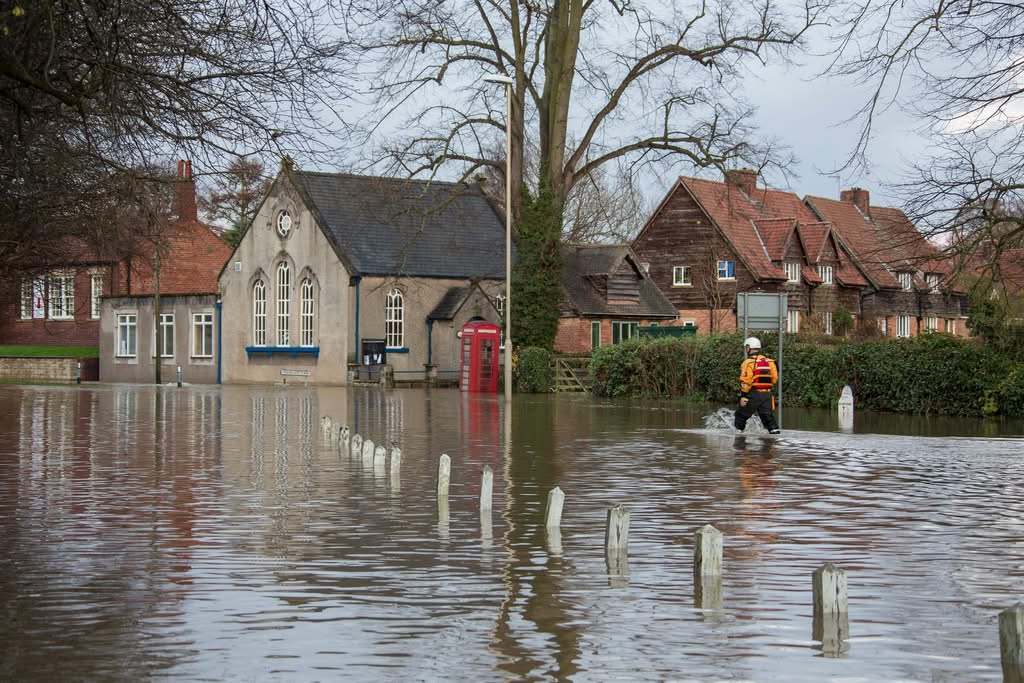 Flooded home exterior representing Always Home Repair flood and water repair service