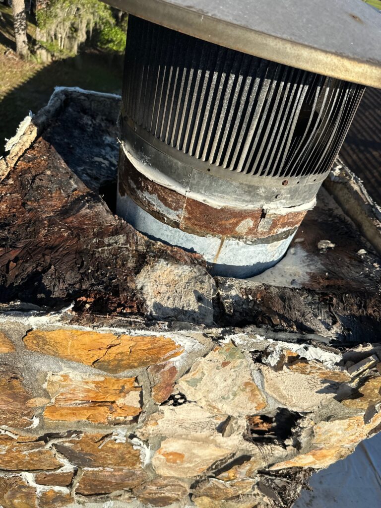 licensed technician measuring clearance during wood chimney framing details inspection
