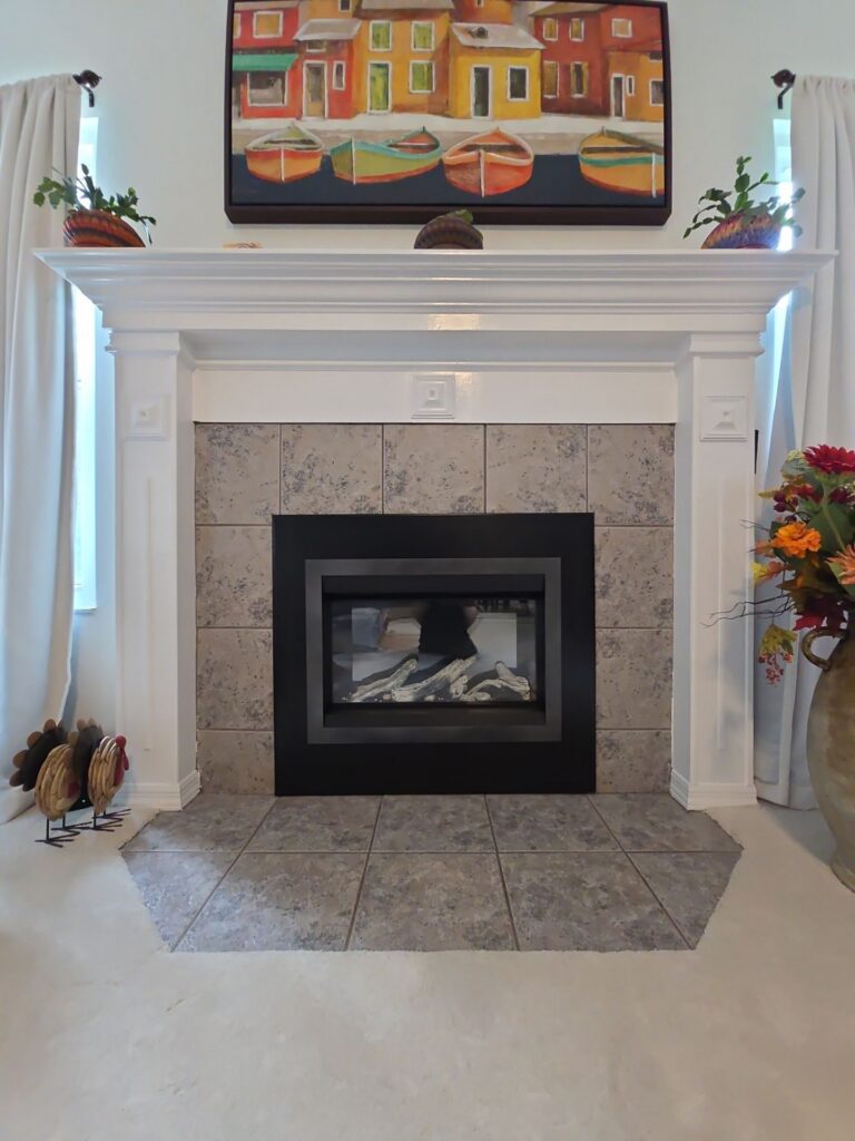stone fireplace surround with wood mantel shelf in an Ocala living room