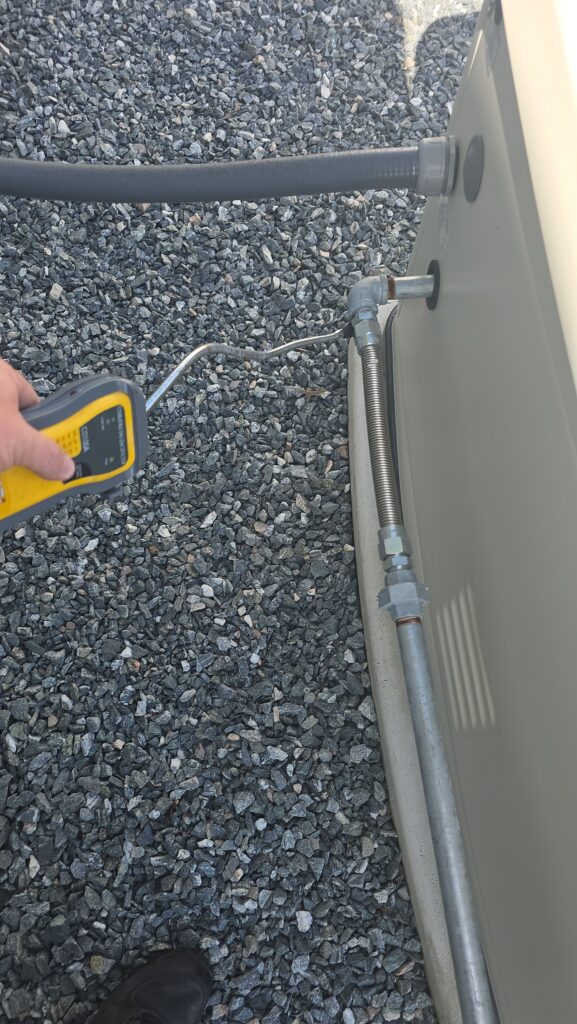 technician checking gas line connection for gas fireplace inserts in a Marion County home
