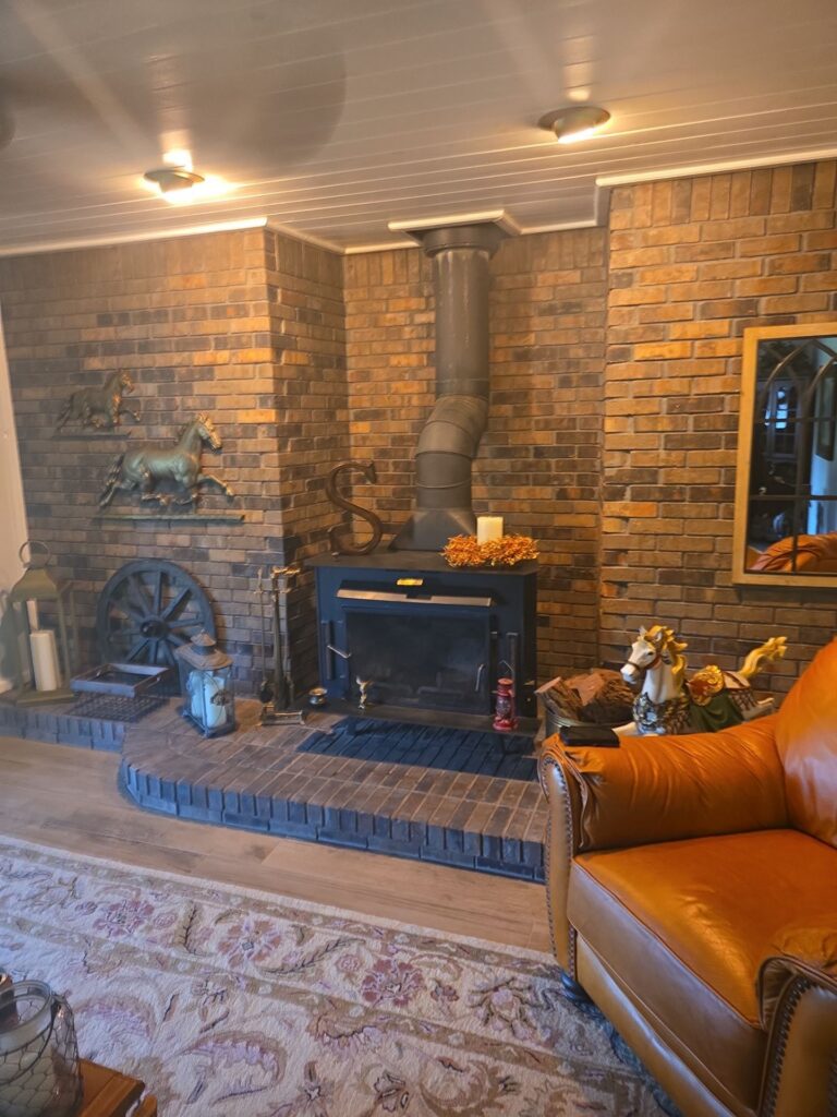 wood chimney mantels installed above a brick fireplace with visible clearance gap